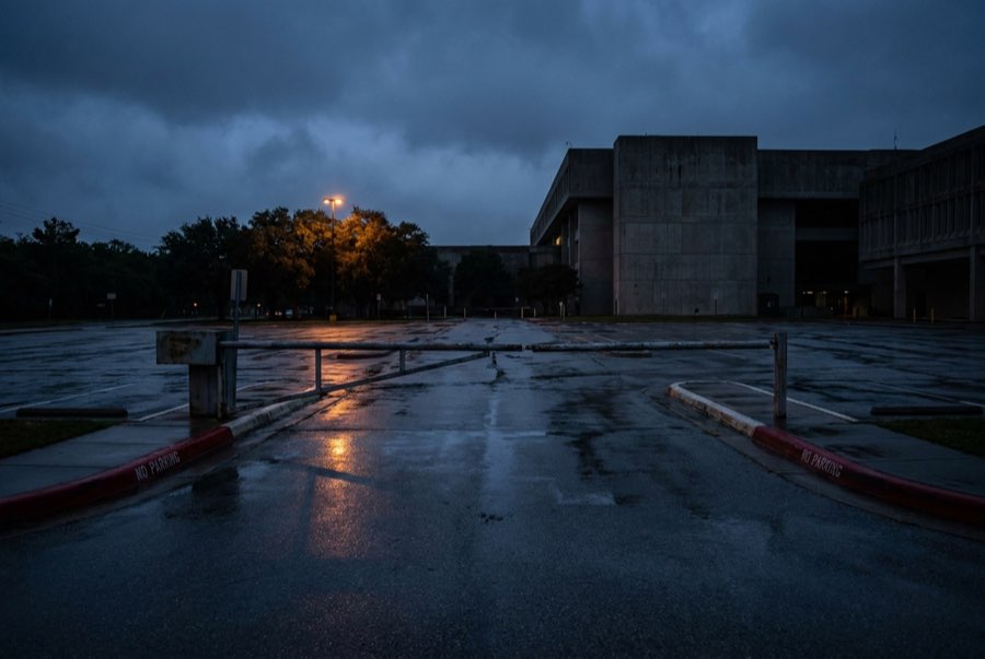 Government building parking area with a barrier gate in the evening